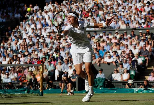 Canada's Milos Raonic returns to Switzerland's Roger Federer during their Men's Singles Quarterfinal Match on day nine at the Wimbledon Tennis Championships in London Wednesday, July 12, 2017.