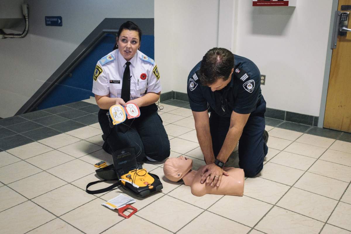 Miranda Bothwell, public education co-ordinator with Middlesex-London EMS, and a London Fire Dept. official demonstrate using a public access defibrillator.