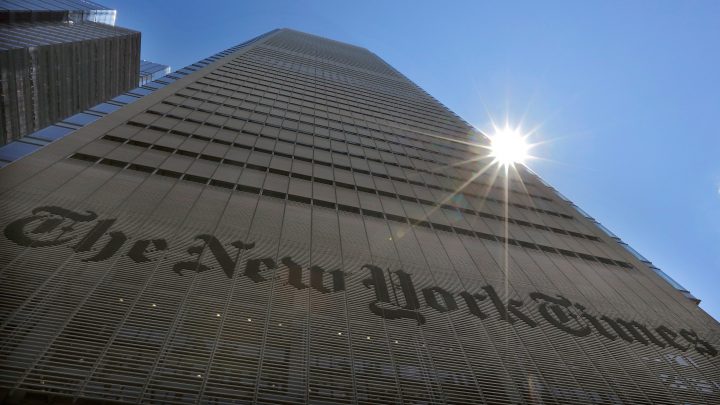 The sun peeks over the New York Times Building in New York, U.S., on August 14, 2013.  