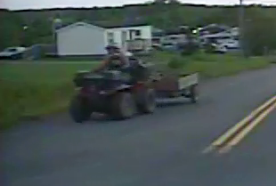 A close-up image of a man driving an ATV. Police released this dash cam footage because they say two children were seated on the ATV not wearing appropriate safety equipment.