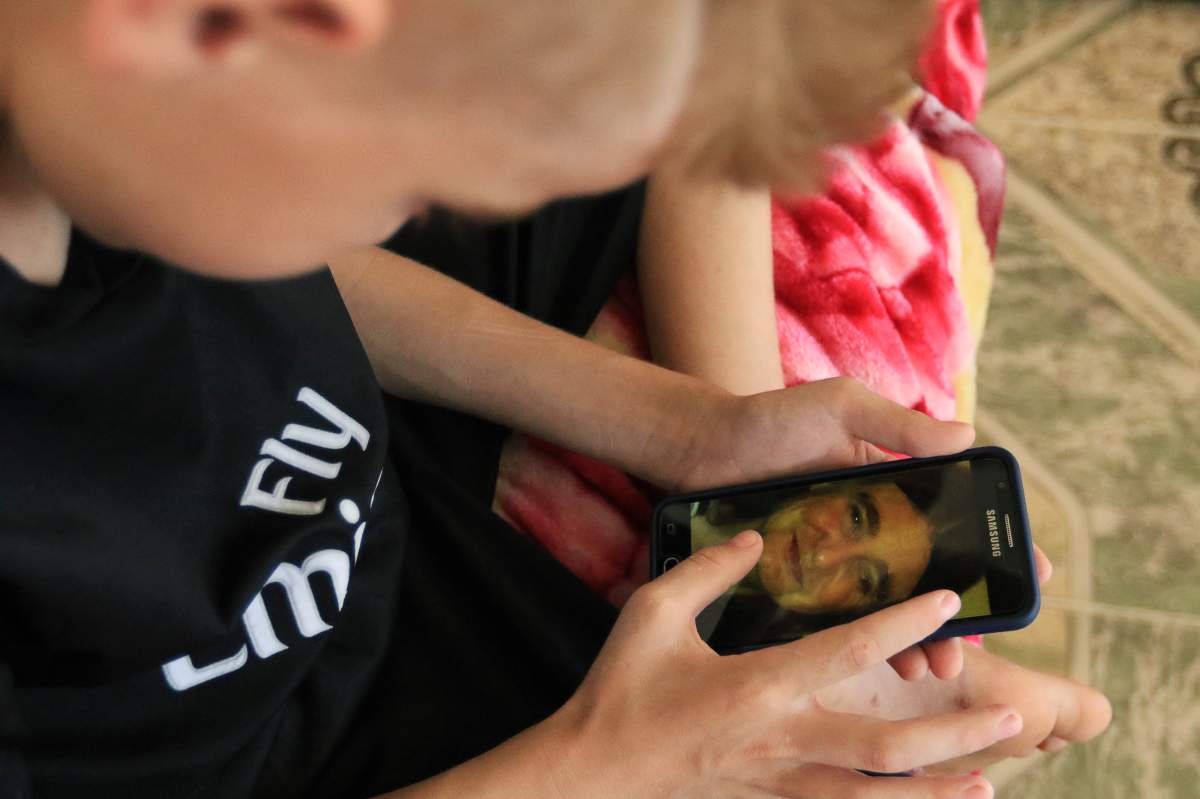 A Yazidi boy, twelve year-old Emad Tammo rescued from so-called Islamic State militants by the Iraqi army, looks at a picture of his mother in Sina neighbourhood outside of Duhok, Iraq July 25, 2017.