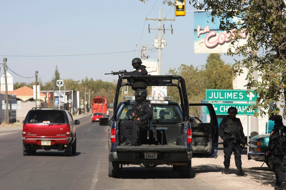 Mexican federal police officers man a roadblock in the town of Meoqui, state of Chihuahua, northern Mexico, Monday Nov. 29, 2010.