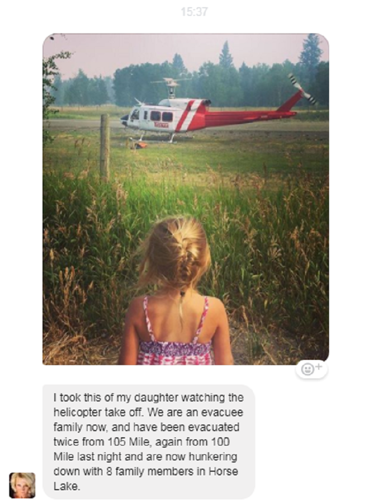 After being evacuated twice from 105 Mile, Rywaczuk\’s daughter watches as the helicopter takes off.