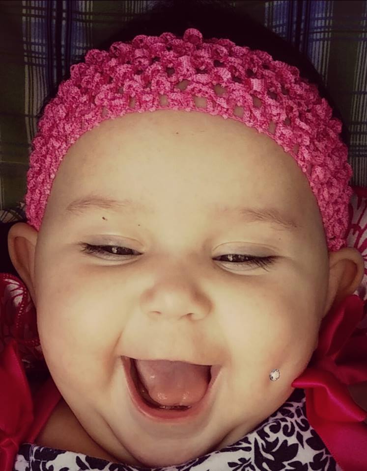 An altered photo of the daughter of Enedina Vance, which shows a fake piercing in her left dimple, to make a point.