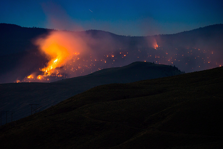 A wildfire burns on a mountain near Ashcroft, July 7, 2017.