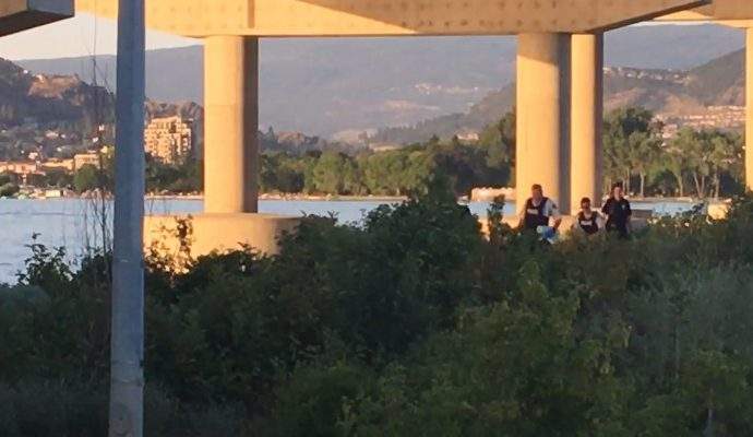 Emergency crews return from where a woman was discovered under the Bennett Bridge Wednesday evening. 