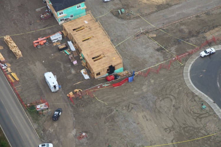 An aerial view of the scene of the discovery of three bodies inside a burning car in Calgary on July 10, 2017.