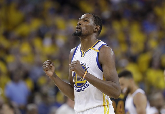 FILE - In this June 12, 2017 file photo, Golden State Warriors forward Kevin Durant reacts after scoring against the Cleveland Cavaliers during the second half of Game 5 of basketball's NBA Finals in Oakland, Calif.