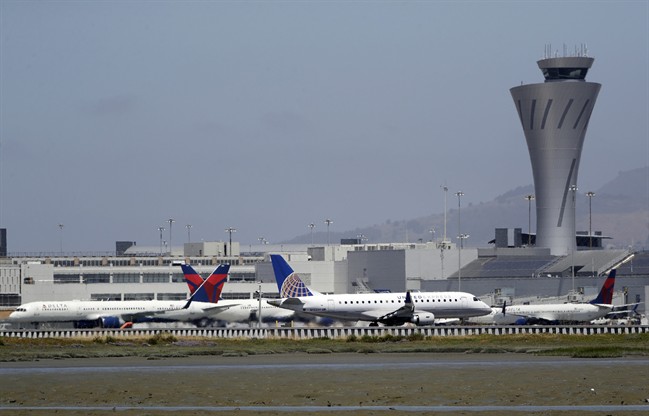 Departing and parked aircraft intersect at San Francisco International Airport, Tuesday, July 11, 2017.