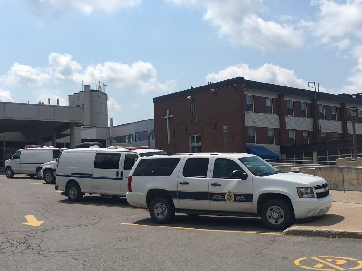 CBSA and Quebec public security trucks sit outside Santa Cabrini Hospital after four men were found inside a shipping container at the Port of Montreal, Thursday, July 20, 2017.