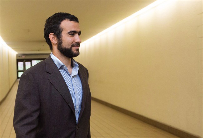 Omar Khadr leaves court after a judge ruled to relax bail conditions in Edmonton on Friday, Sept. 18, 2015. The Canadian government will pay former Guantanamo Bay prisoner Omar Khadr more than $10 million and officially apologize to him in settlement of a long-running lawsuit.