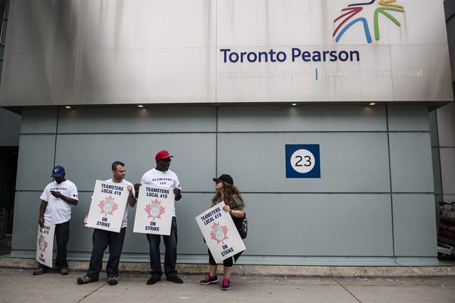 Striking workers seen picketing at Pearson International Airport in Toronto on Friday, July, 28, 2017. 