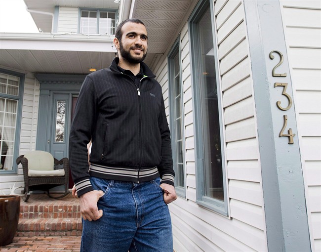 Omar Khadr walks out of his lawyer Dennis Edney's home to speak with the media in Edmonton, in spring 2015. The government is investigating who leaked information related to a settlement with Khadr to the press in early July.