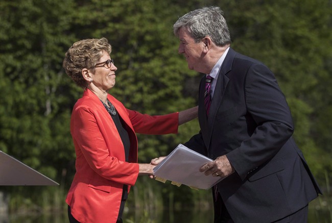 Ontario Premier Kathleen Wynne, left, shakes hands with Minister of the Environment and Climate Change Glen Murray in Toronto, Wednesday June 8, 2016.