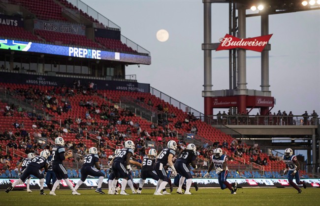 The moon rises as the Toronto Argonauts play the Montreal Alouettes during the first half of CFL pre-season football action in Toronto, Thursday June 8, 2017. 