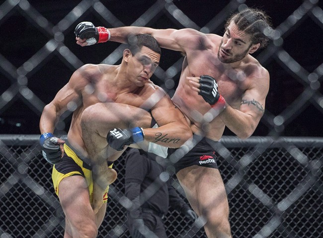 Elias Theodorou, right, of Mississauga, Ont., battles Cezar Ferreira, of Brazil, in middleweight UFC Fight Night action, in Halifax on Feb. 19, 2017. 