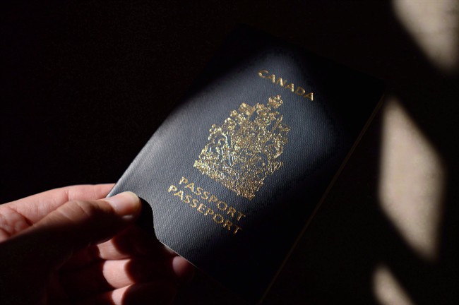 A Canadian passport is displayed in Ottawa on Thursday, July 23, 2015. 