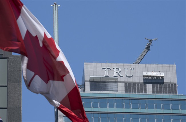Workers start to take down the letters off a Trump Hotel in Toronto on Tuesday July 18, 2017. JFC Capital ULC, the new owners of Trump International Hotel and Tower, reached a buyout deal with Trump Hotels last month.