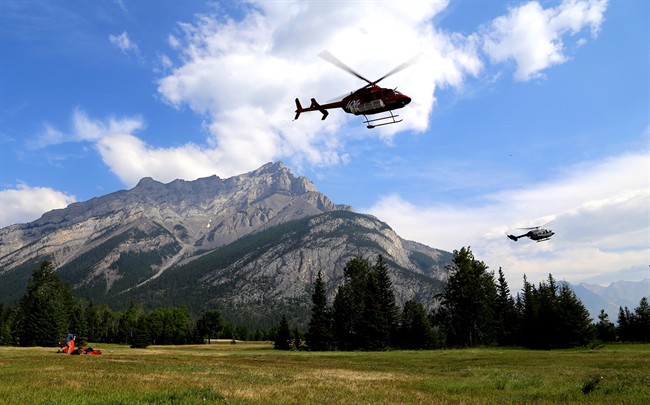 Helicopters are seen leaving a fire base for the Verdant Creek wildfire in an undated Parks Canada handout image. 