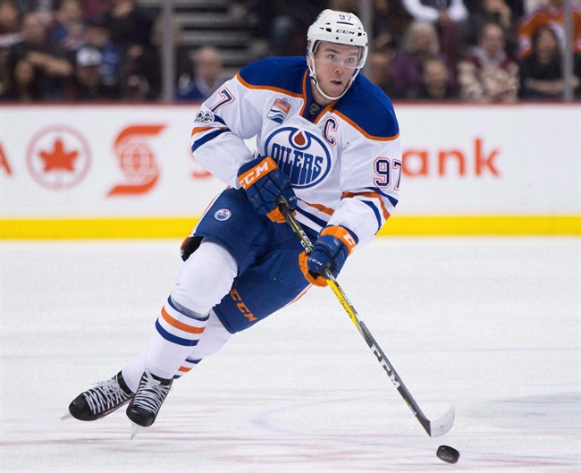 Edmonton Oilers' Connor McDavid skates with the puck during first period NHL hockey action against the Vancouver Canucks, in Vancouver, B.C., on Saturday, April 8, 2017. The Edmonton Oilers have signed star captain Connor McDavid to an eight-year deal with an average annual value of US$12.5 million.The Oilers announced the contract at a press conference today. THE CANADIAN PRESS/Darryl Dyck.