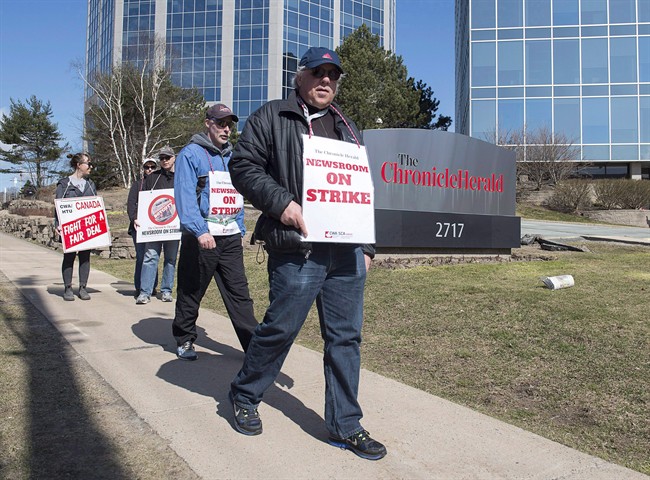 Striking journalists walk outside the Chronicle Herald building in Halifax, April 13, 2017.