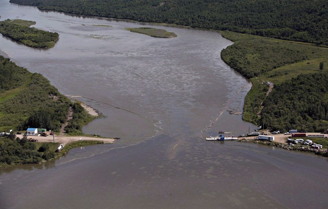 Crews work to clean up an oil spill on the North Saskatchewan River near Maidstone, Sask. on Friday, July 22, 2016. A year after a major oil spill along the North Saskatchewan River fouled the water source for three Saskatchewan cities, an environmentalist says the company involved should get more than just "a slap on the wrist."