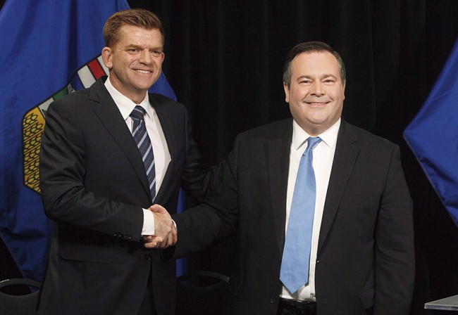Alberta Wildrose leader Brian Jean and Alberta PC leader Jason Kenney shake hands after announcing a unity deal between the two in Edmonton on May 18, 2017.
