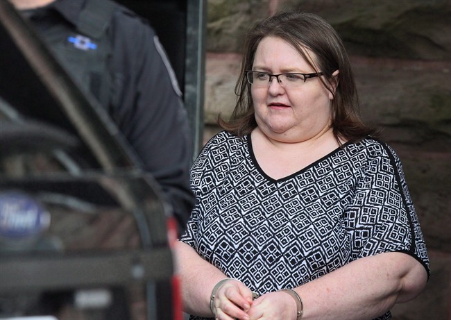 Elizabeth Wettlaufer is escorted by police from the courthouse in Woodstock, Ont, Monday, June 26, 2017.
