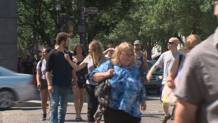 Edmontonians cross an Old Strathcona street on July 7, 2017 while traffic lights were out.