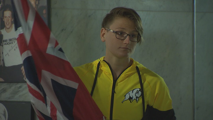 Winnipeg rower Emma Gray holds the Manitoba flag during an event unveiling her as the province's flag bearer for the opening ceremonies of the Canada Summer Games.