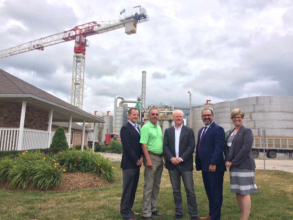 Ontario's Energy Minister Glenn Thibeault stands with politician's and the IGPC CEO Jim Grey outside the production plant in Aylmer.