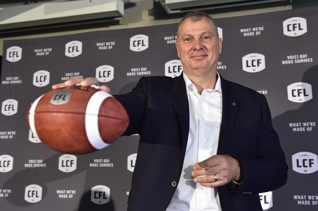 Randy Ambrosie holds a football as he speaks during a press conference in Toronto, Wednesday July 5, .