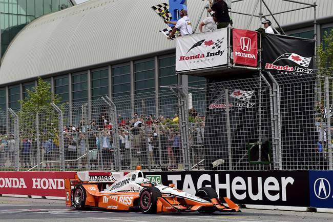 Josef Newgarden crosses the finish line to win the Honda Indy Toronto in Toronto on Sunday, July 16, 2017. 