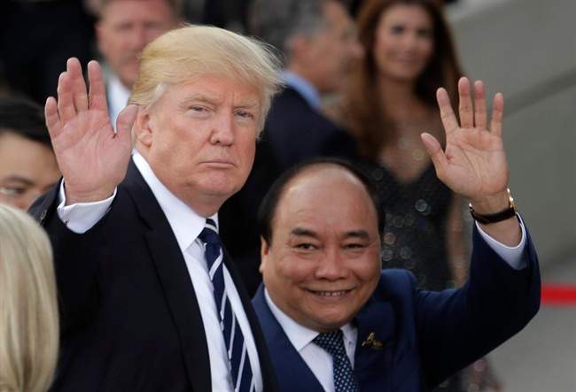 U.S. President Donald Trump, left, and Vietnamese Prime Minister Nguyen Xuan Phuc wave prior to a concert on the first day of the G-20 summit in Hamburg, northern Germany, Friday, July 7, 2017. The leaders of the group of 20 meet July 7 and 8. 