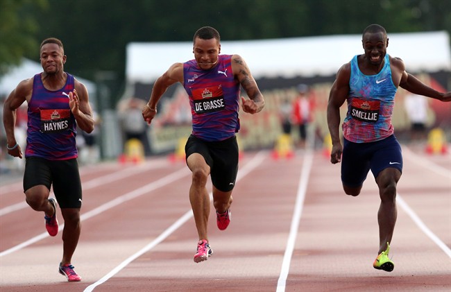Andre De Grasse, centre, of Toronto, powers over the finish line to win gold in the men's 100-metre race at the Canadian Track and Field Championships in Ottawa, Friday, July 7, 2017.