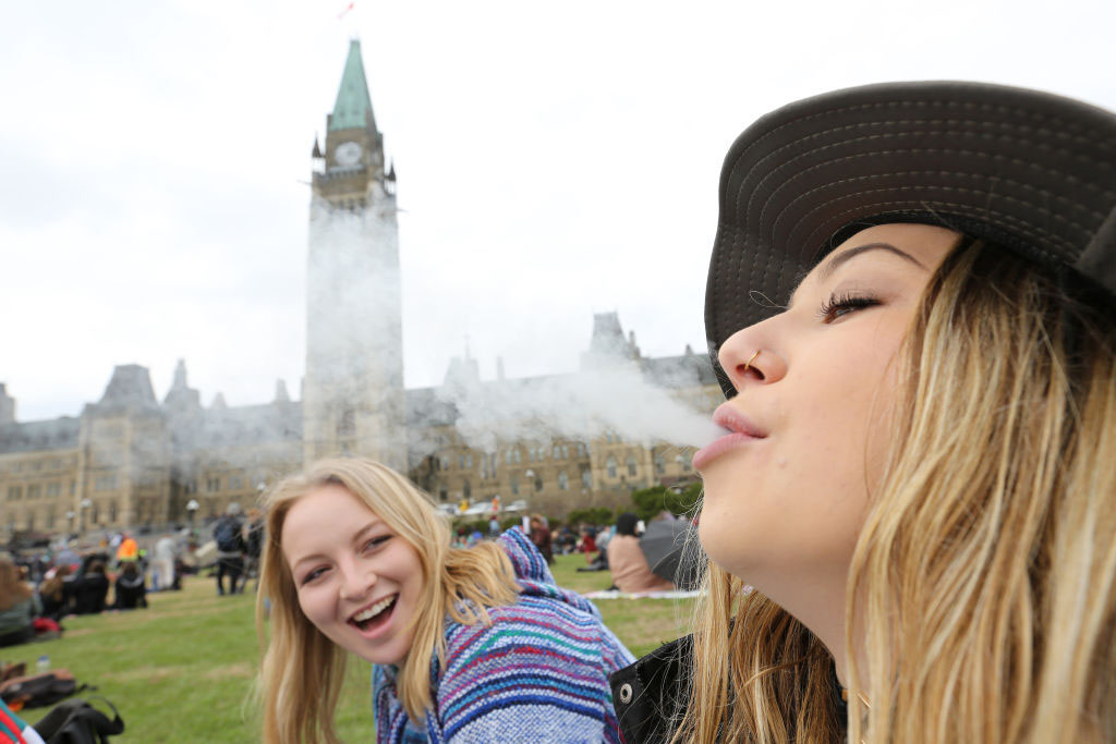 Two women smoke marijuana on Parliament Hill in Ottawa, April 20, 2017. 