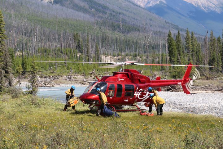 Helicopter crew loading Parks Canada July 31