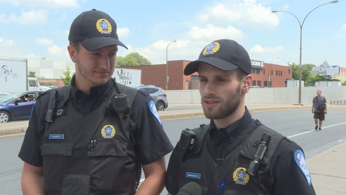 Montreal police constables  Simon Lavoie, left, and partner Rafael Beaulieu at the Victoria Avenue underpass near Jean Talon, in Montreal, Tuesday July 11, 2017. They rescued a woman from a car in the flooded underpass, Saturday July 8.  Phil Carpenter / Global News.