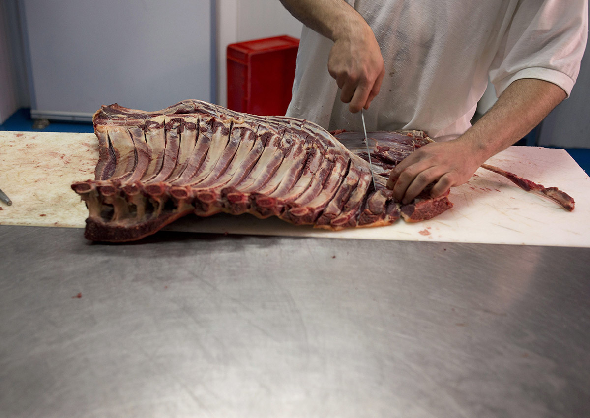 In this file photo taken on Tuesday, April.9, 2013, a butcher prepares a piece of a Pure Spanish Breed horse meat.