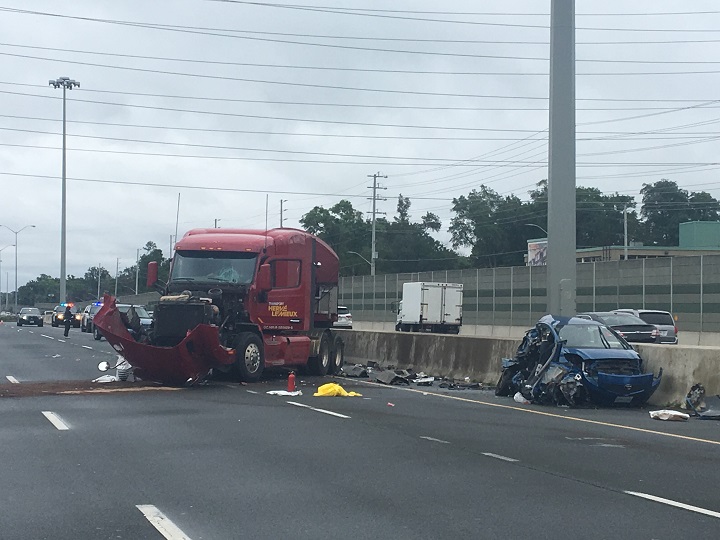 OPP investigate the scene of a multi-vehicle collision on the QEW in Mississauga, Ont., on July 13, 2017.