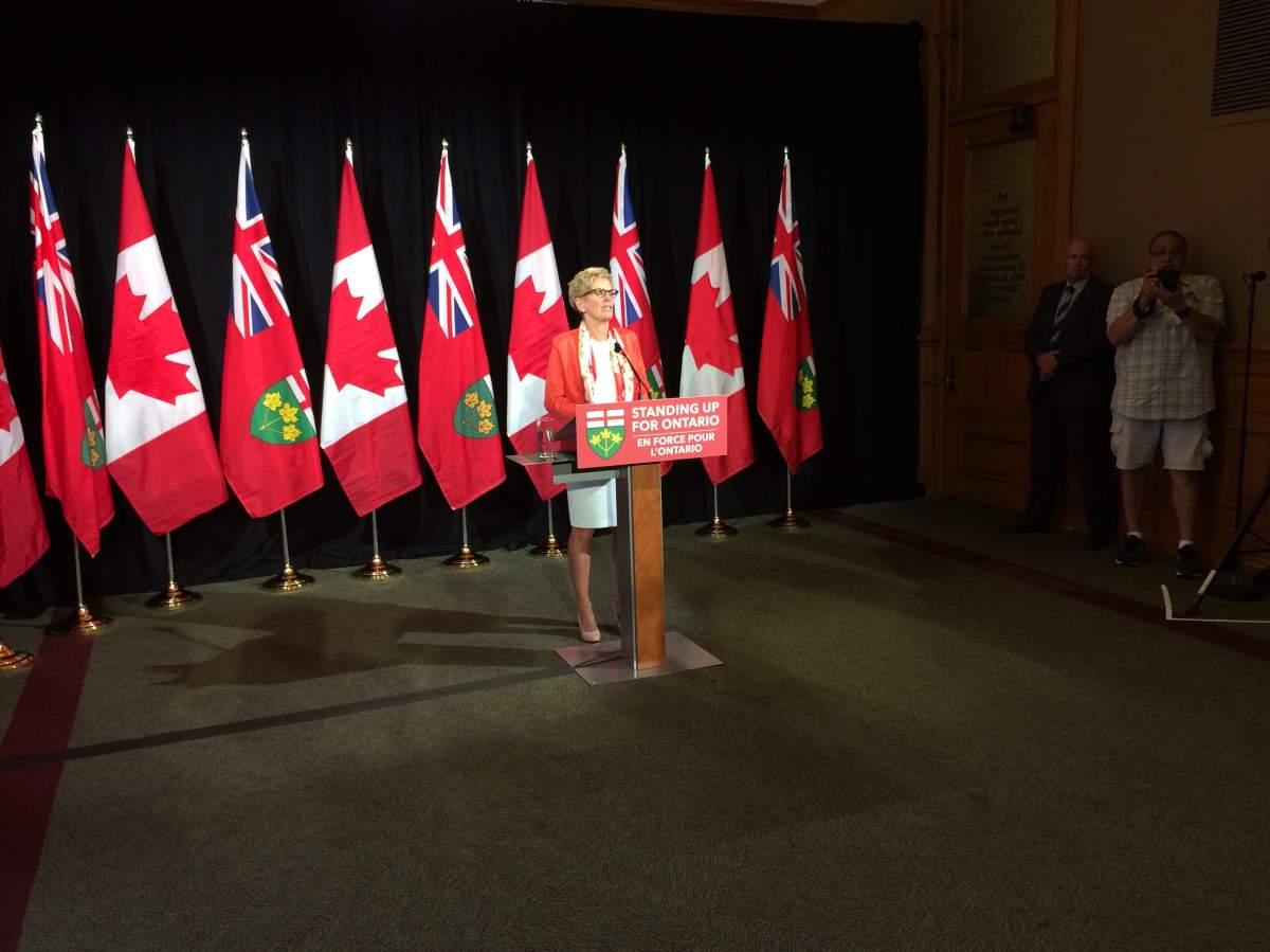 Premier Kathleen Wynne talks to reporters at Queen's Park on July 13, 2017.