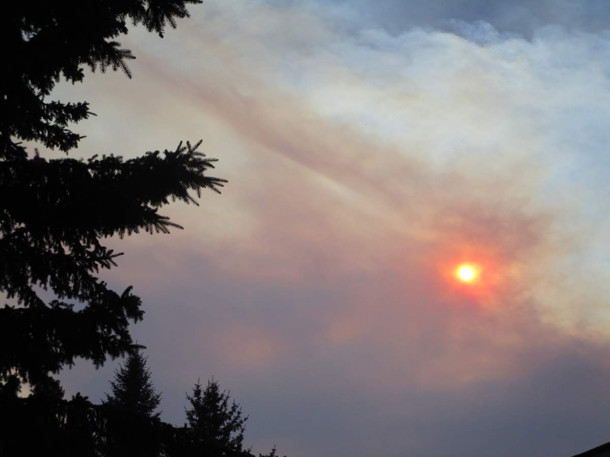 The sun is seen behind a plume of smoke in Calgary on Sunday, July 30. 