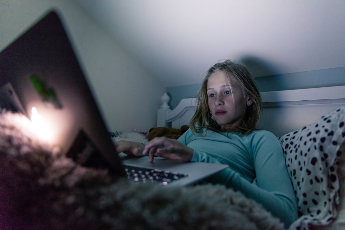 Girl in bed on computer
