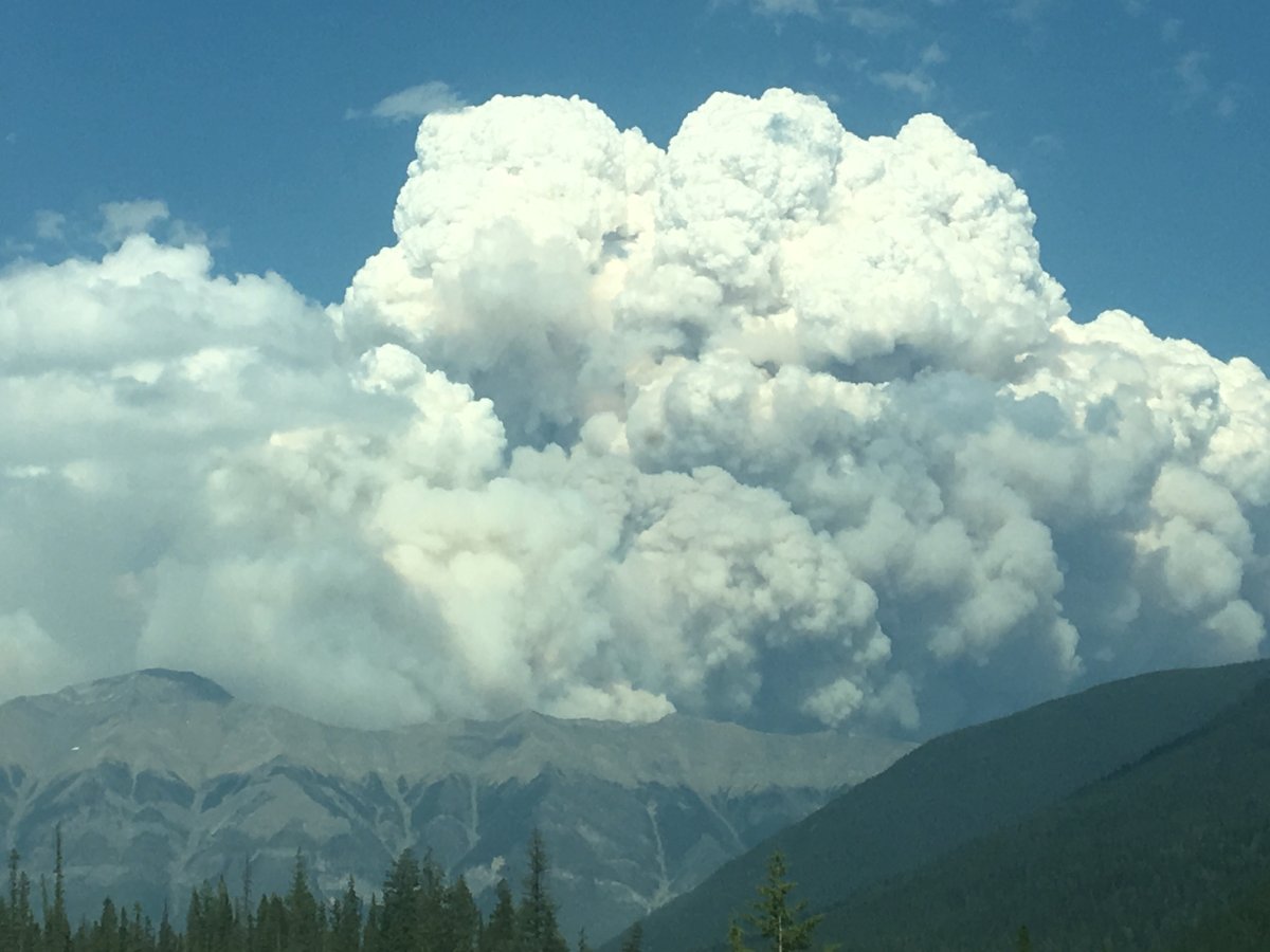 Smoke billows in the Rocky Mountains as a wildfire burns in Kootenay National Park. 