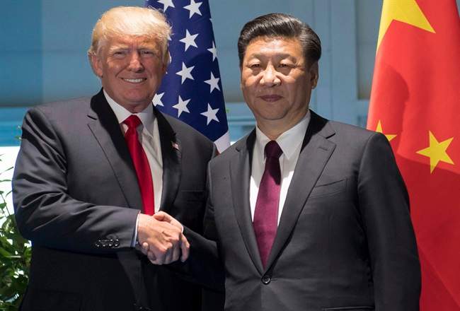 US President Donald Trump and Chinese President Xi Jinping, right, shake hands as they arrive for a meeting on the sidelines of the G-20 Summit in Hamburg, Germany, Saturday, July 8, 2017.