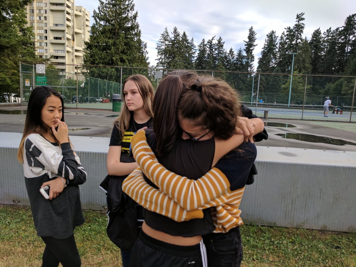 Classmates of murdered teenager Marrisa Shen embrace at a vigil remembering the 13-year-old.