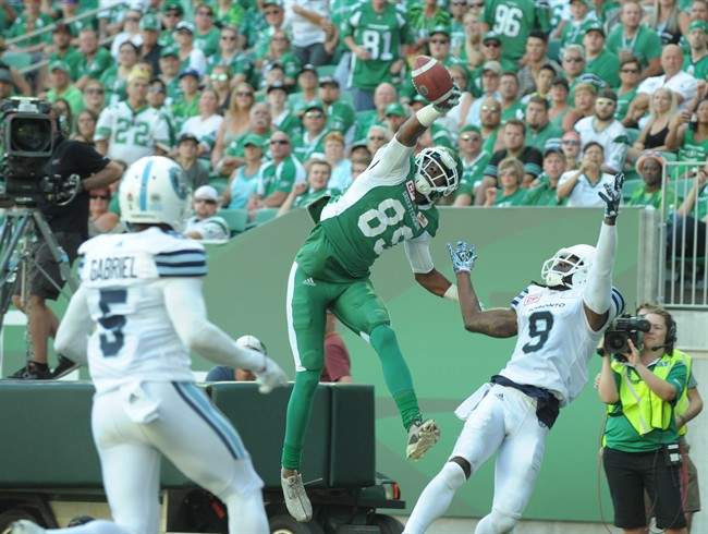 Saskatchewan Roughriders wide receiver Duron Carter (89) makes a one-handed grab for a touchdown in front of Toronto Argonauts defensive back Akwasi Owusu-Ansah (9) during first half CFL football action in Regina on Saturday, July 29, 2017.