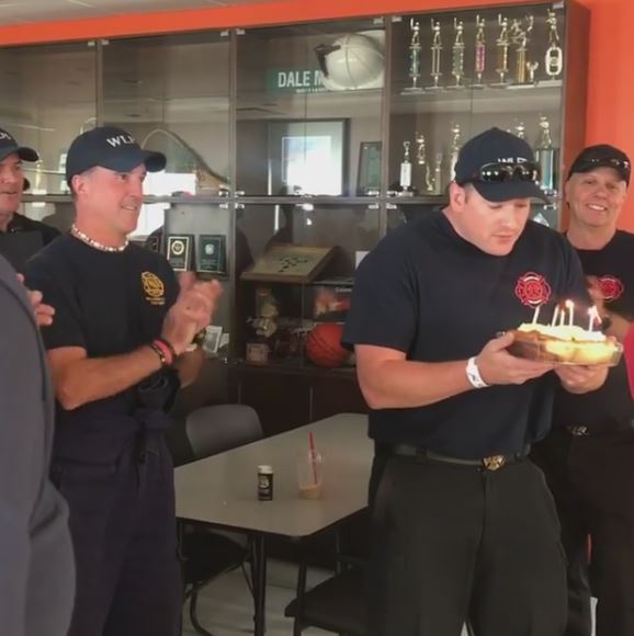 Firefighter Nick West blowing out his birthday candles.