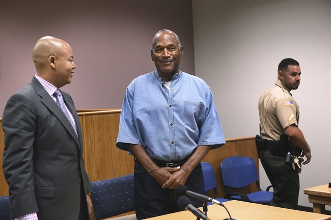 Former NFL football star O.J. Simpson, center, enters for his parole hearing at the Lovelock Correctional Center in Lovelock, Nev., on Thursday, July 20, 2017. 