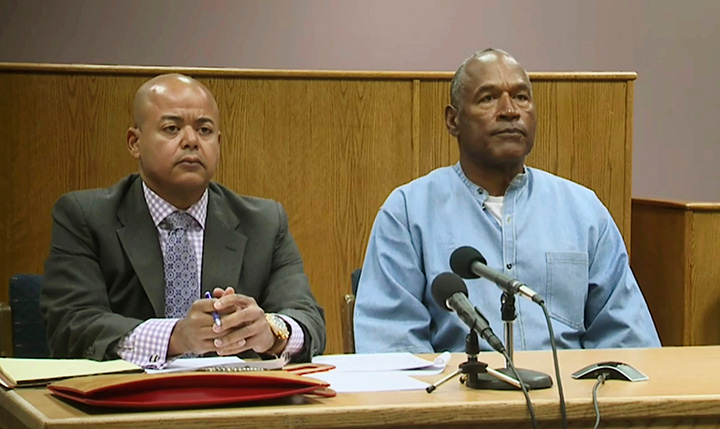 Former NFL football star O.J. Simpson appears with his attorney, Malcolm LaVergne, left, via video for his parole hearing at the Lovelock Correctional Center Nevada, on Thursday, July 20, 2017.  